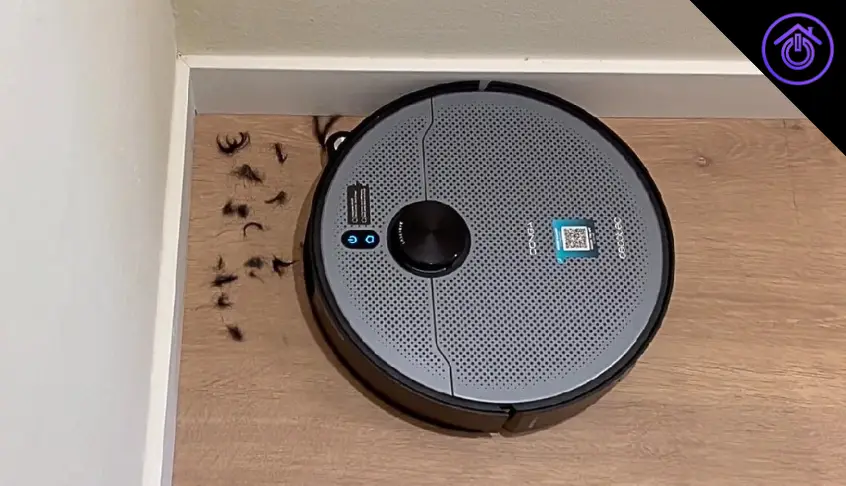 robot aspirador conga limpiando esquina con pelos